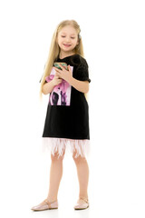 The girl is using a cell phone.The concept of people and technology.