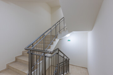 Modern stair case between floors. Stairs with metallic rail  in modern building - Powered by Adobe