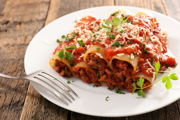 canelloni- pasta with minced beef, tomato sauce and cheese
