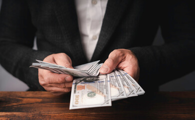 Business executive in formal suit Counting money that is bribe In order to offer or receive Bribe...