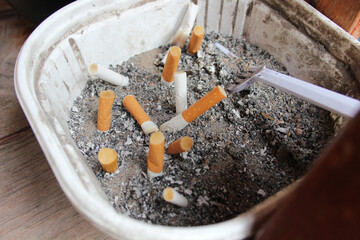 Picture of used cigarette butts in a dump