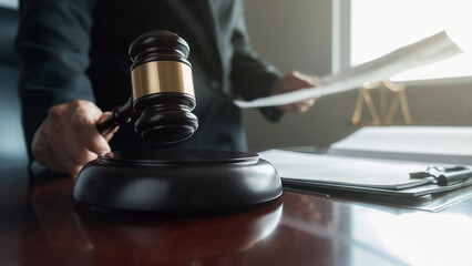 udge gavel with Justice lawyers having team meeting at law firm background. Concepts of Law and Legal services.