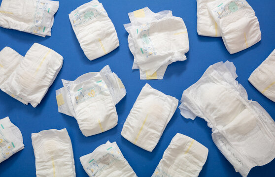 Baby diapers collection on blue color background.