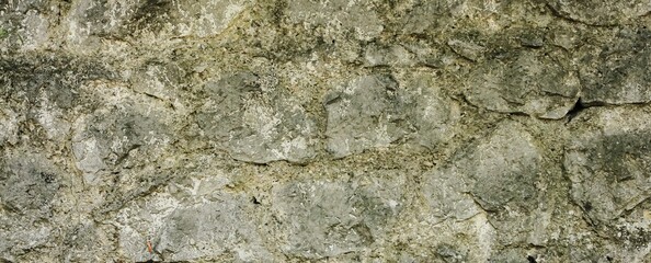 Natural old beige stone wall textured banner. Close up. Copy space.	