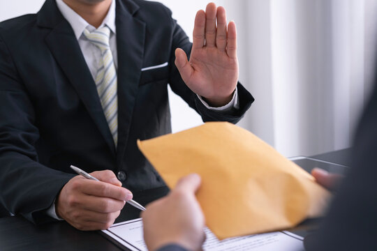 Businessman or accountant is rejecting and resisting partner bribery deals in joint financial settlement, illegal anti-bribery ideas. In work