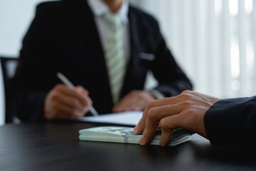 Businessmen submitting illegal money bribes in the form of cash For use in bribery of contracting his partners in illegal business practices, the idea of ​​giving and receiving illegal bribes.