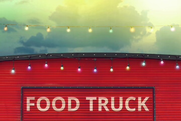 detail of closed red food truck with light bulb in colored sky background, no people