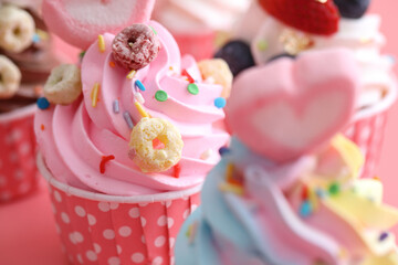 Colorful cupcakes isolated in pink background