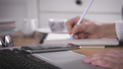 Fototapeta premium working at home, Girl uses more technological device for communicate and work.