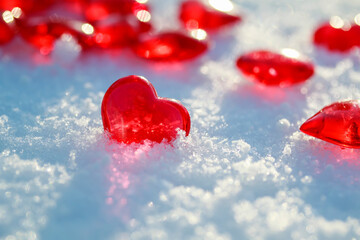 festive background with transparent red love symbols hearts lying on the snow