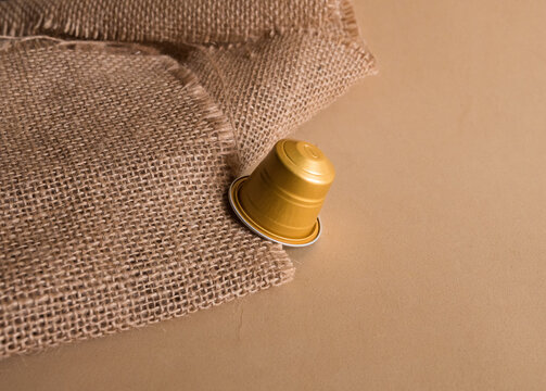 golden capsule of coffee on table