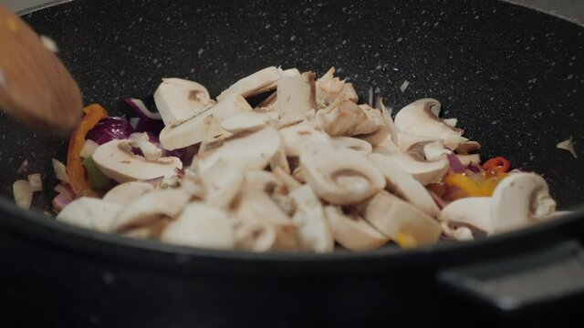 Motion controlled slow motion shot of mushrooms in a cooking pan