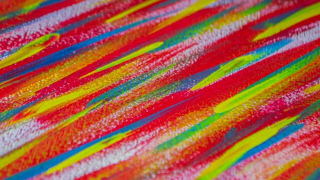 Bright variegated multicolored background of brush strokes with different paint