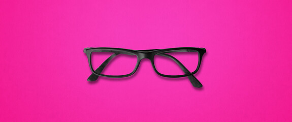 Black glasses isolated on pink banner