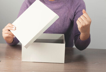 happy young woman hand open white box