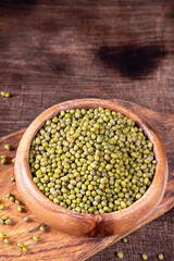 Mung. Green mung beans in a bowl on a brown wooden table. Legume plant for a healthy diet	
