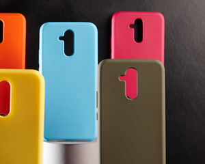 colorful cases for modern smartphones stand on stands on the table one object in focus blurred background