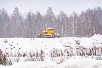 Snow clearing. Tractor clears the way after heavy snowfall.