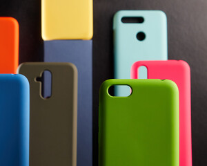 colorful cases for modern smartphones stand on stands on the table one object in focus blurred background