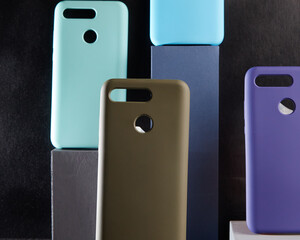 colorful cases for modern smartphones stand on stands on the table one object in focus blurred background