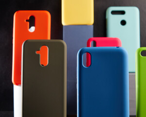 colorful cases for modern smartphones stand on stands on the table one object in focus blurred background