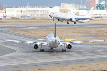 Airplane waiting for another landing on the runway.