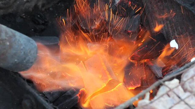 lighting barbecue coals with fire gas burner