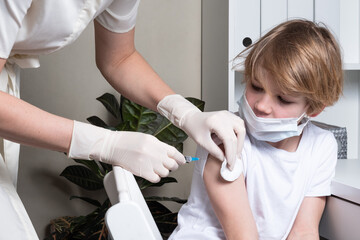 Coronavirus, flu or measles vaccine concept. Child, teenage boy vaccination. He have face mask. Coronavirus epidemic.