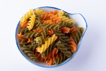 Macaroni in ceramic cup on white background