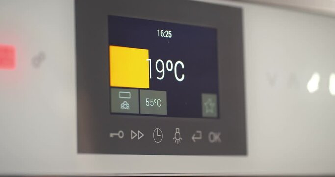 Close up of sensor panel of modern electric thermometer showing air temperature in room