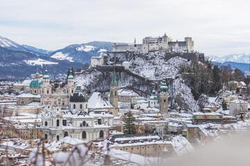 Fototapeta premium Panorama of Salzburg in winter: Snowy historical center and old city