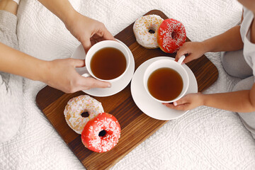 Beautiful woman with child. Woman in a white t-shirt. Family have a breakfast.