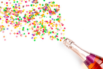 bottel of rose sparkling wine or champagne and colorful confetti on white background with copy space