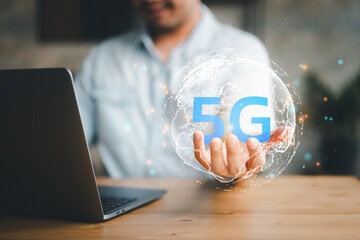 Businessman use computer laptop with the world of 5G, concept of future technology 5G network wireless systems and internet of things.