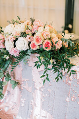 Flower arrangement of roses and eucalyptus on the wedding table.
