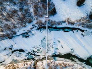 Hanging Suspention Bridge over Frozen San River in Bieszczady Mountains, Poland.