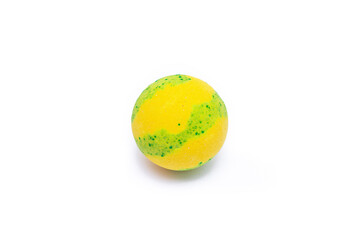 Yellow-green bubbling round bright bath bomb isolated on a white background. Close-up of aroma bath salts