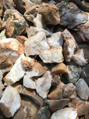 white quartz stones inlaid with minerals such as gold, silver, cilice and bronze, extracted from an artisanal mine
