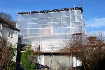 Fabric weather protection over property roof during construction work