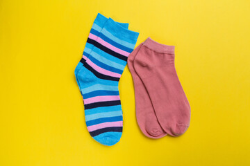 View from above. Socks are scattered on a yellow background. Clothing in the form of socks.