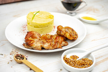 fried chicken with mustard and honey sauce with mashed potato on white plate