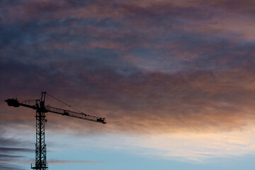 Silhouette of a crane with purple sky