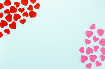Red and pink paper hearts Valentines Day on blue background. 