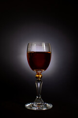 alcoholic drink in a glass on a black background
