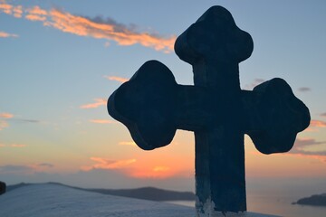 Blue cross in a sunset in Santorini