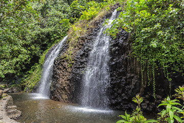 Fototapeta na wymiar Idyllic Tropical Waterfall on the island of Tahiti, French Polynesia. Pacific Ocean.