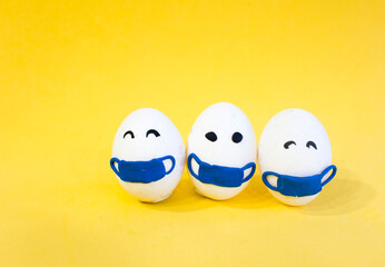 Chicken eggs in medical masks on the face. The concept of the Easter 2021 holiday in relation to...