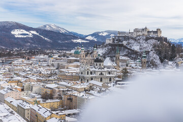 Fototapeta na wymiar Panorama of Salzburg in winter: Snowy historical center and old city