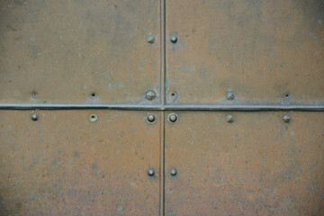 Background divided into four parts made from a copper plate that has been weathered