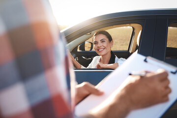 Young woman in car near her instructor outdoors. Driving school